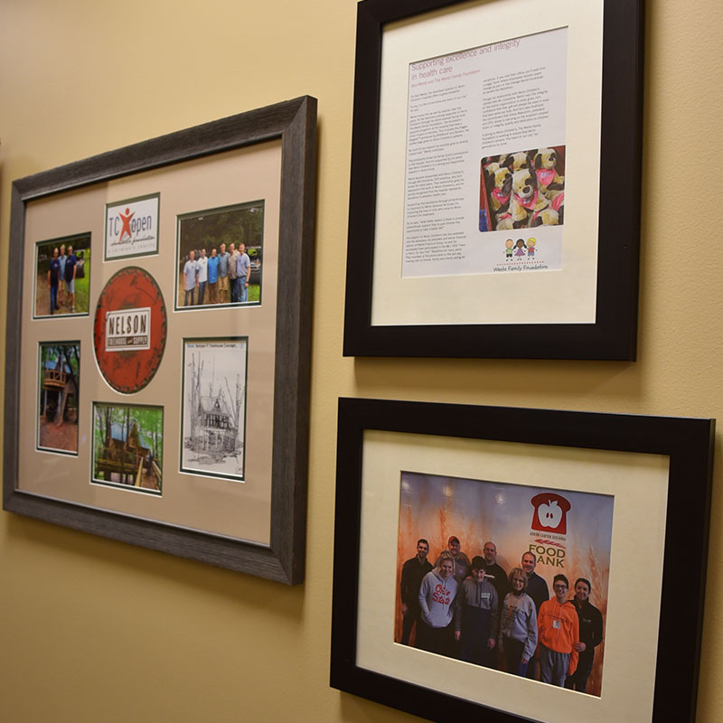 Pictures hanging on a wall depicting charities